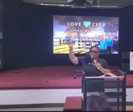 Sharrone sharing her testimony at Love Life Prayer Walk June 2025 MI